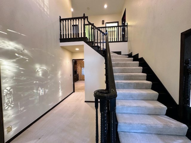 stairway with a towering ceiling