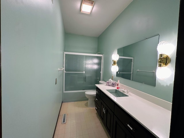 full bathroom featuring vanity, toilet, and bath / shower combo with glass door