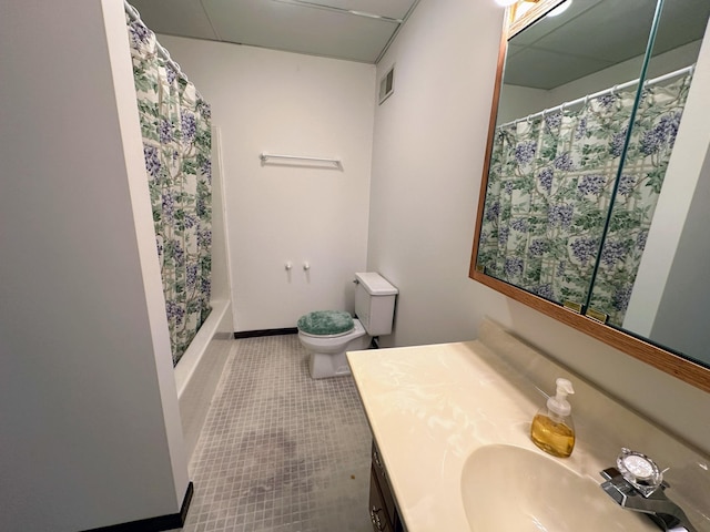 bathroom featuring tile patterned flooring, vanity, and toilet