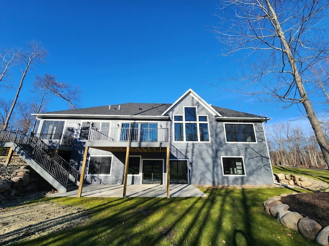 back of house featuring a patio, a yard, and a deck