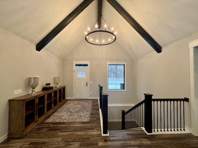 interior space with dark hardwood / wood-style flooring, an inviting chandelier, lofted ceiling with beams, and a textured ceiling