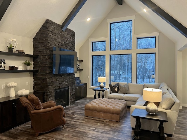 living room featuring beam ceiling, dark wood-type flooring, and a stone fireplace