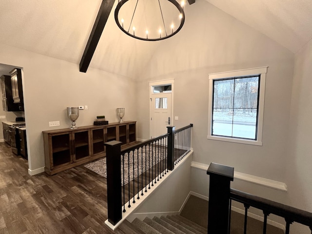 stairway with an inviting chandelier, beam ceiling, high vaulted ceiling, and dark hardwood / wood-style flooring