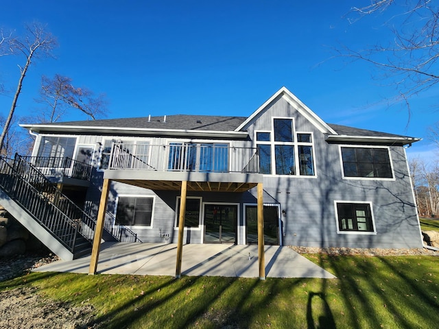 back of property with a patio area and a lawn