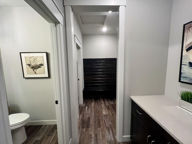 bathroom with a textured ceiling, vanity, toilet, and hardwood / wood-style floors