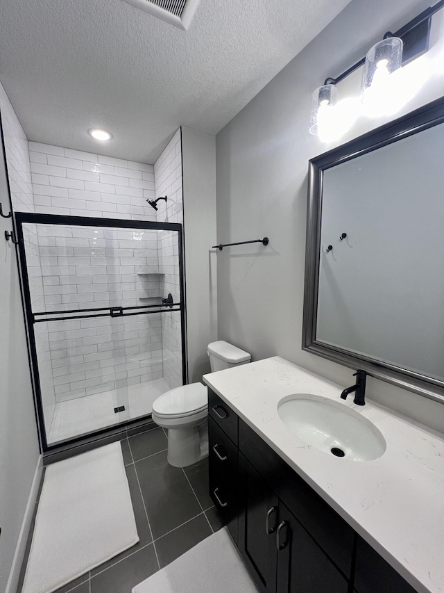 bathroom featuring walk in shower, tile flooring, a textured ceiling, toilet, and vanity