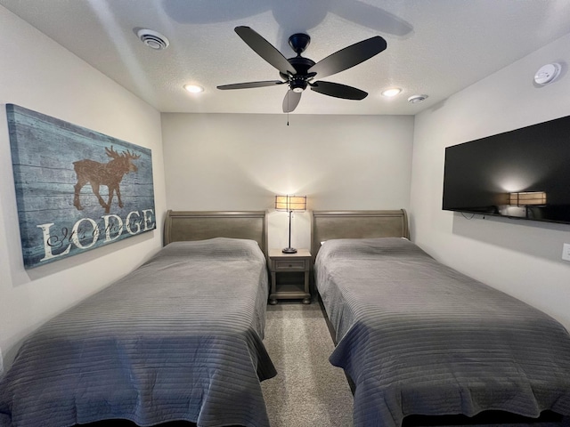 bedroom with a textured ceiling and ceiling fan