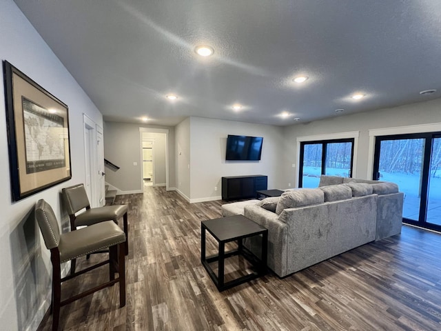 living room with dark hardwood / wood-style floors and a textured ceiling