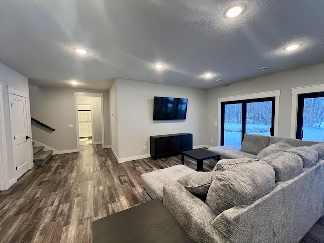 living room with dark wood-type flooring and a textured ceiling