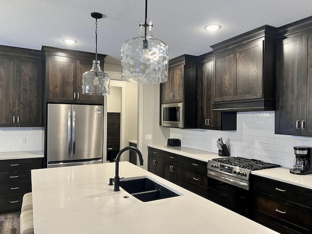 kitchen featuring sink, hardwood / wood-style flooring, stainless steel appliances, and backsplash