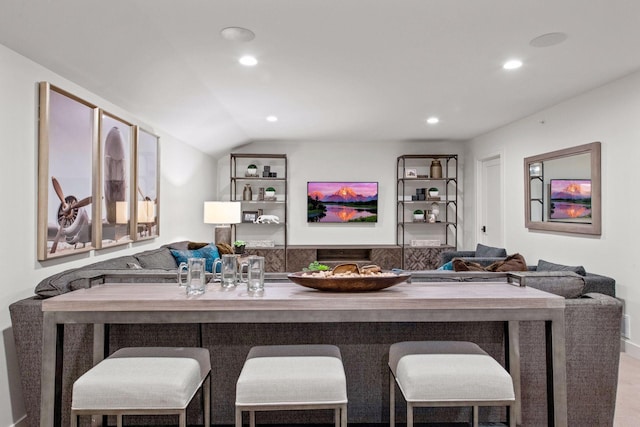 bar featuring lofted ceiling