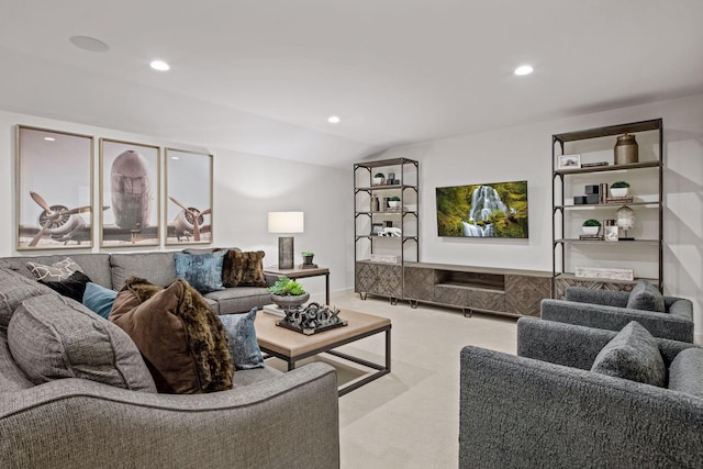 living room with light colored carpet and vaulted ceiling