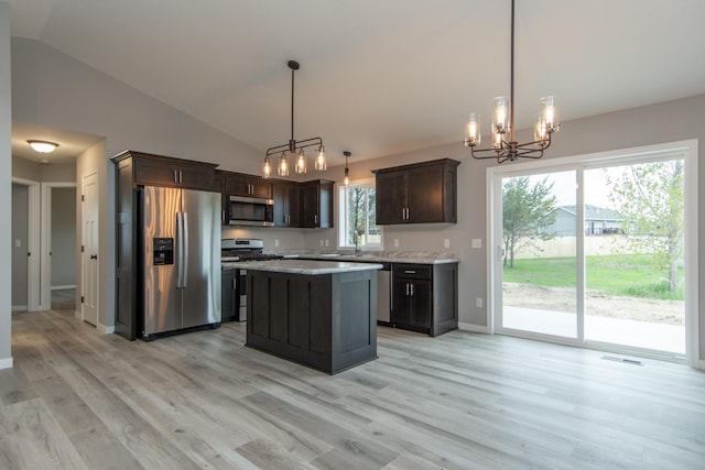 kitchen with light hardwood / wood-style flooring, pendant lighting, and appliances with stainless steel finishes