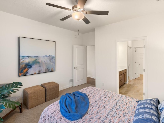 bedroom featuring ceiling fan and ensuite bath