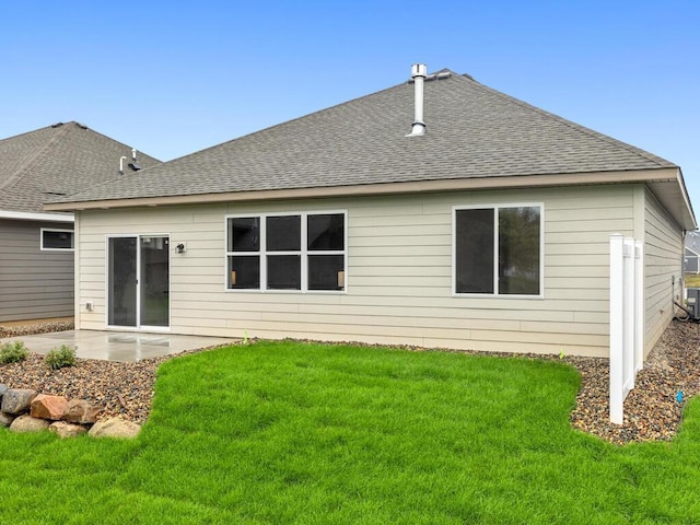 rear view of house with a patio and a lawn