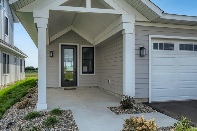 view of exterior entry with a garage