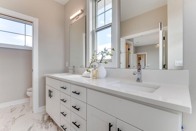 bathroom featuring vanity and toilet