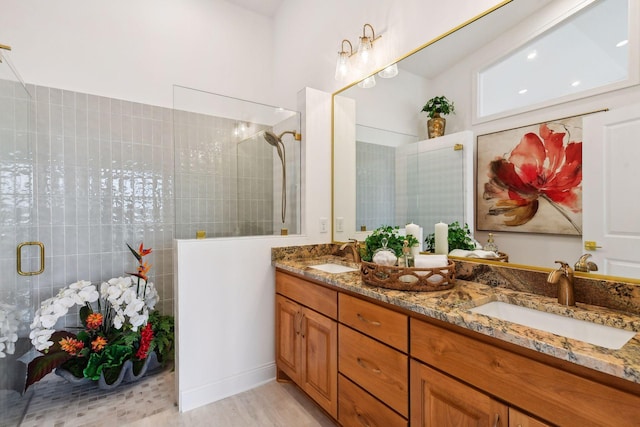 bathroom featuring hardwood / wood-style floors, vanity, and walk in shower