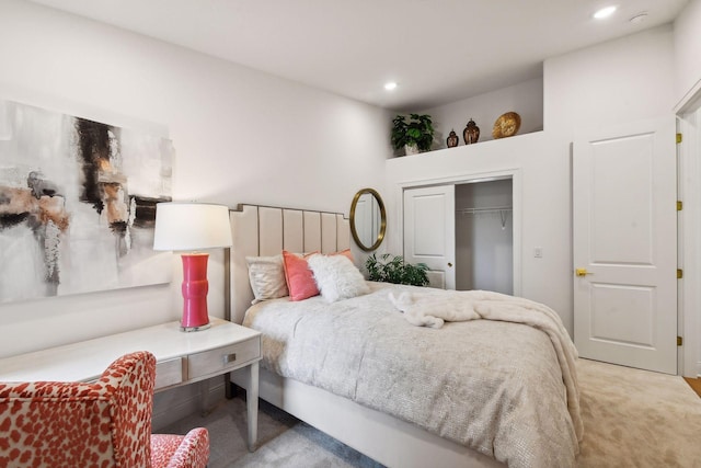 bedroom with light carpet and a closet