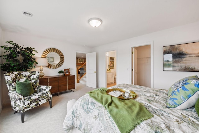 carpeted bedroom featuring ensuite bathroom, a spacious closet, and a closet