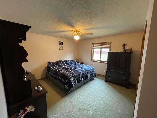 bedroom featuring a textured ceiling, ceiling fan, and carpet floors