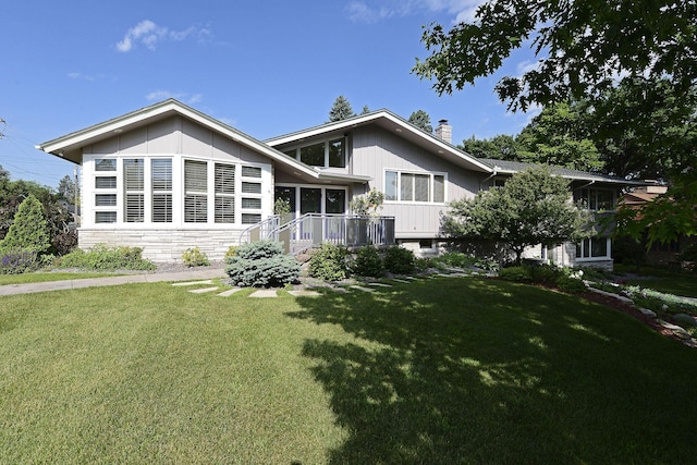 rear view of house featuring a lawn