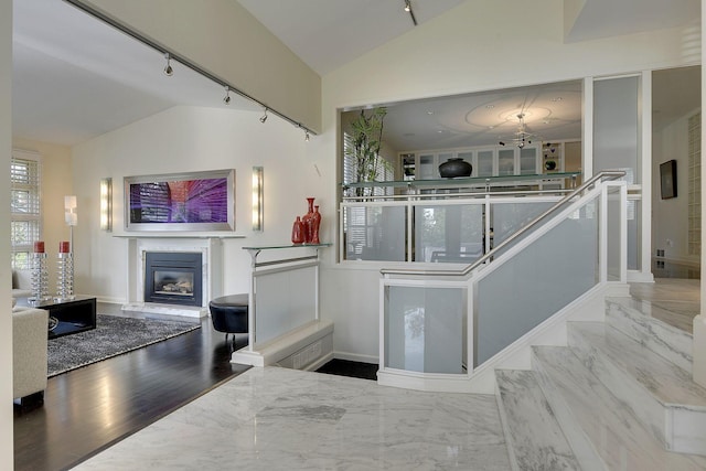 kitchen featuring light hardwood / wood-style flooring, track lighting, and vaulted ceiling