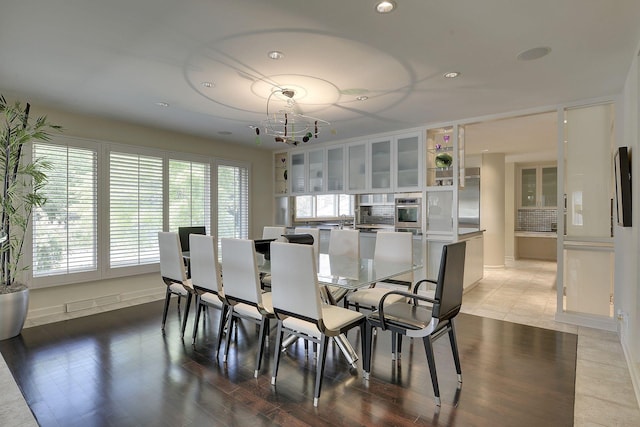 tiled dining space with a notable chandelier