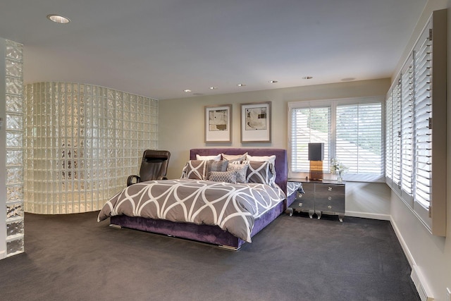 bedroom with dark colored carpet