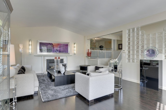 living room with lofted ceiling and dark hardwood / wood-style flooring