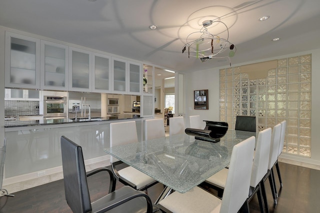 dining room featuring sink and dark wood-type flooring