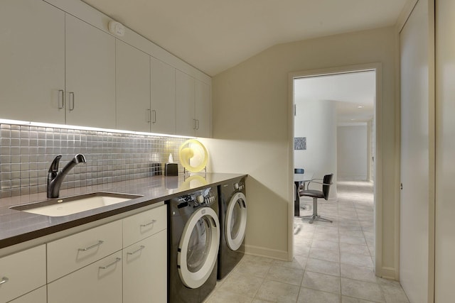 laundry room featuring cabinets, sink, and washing machine and clothes dryer