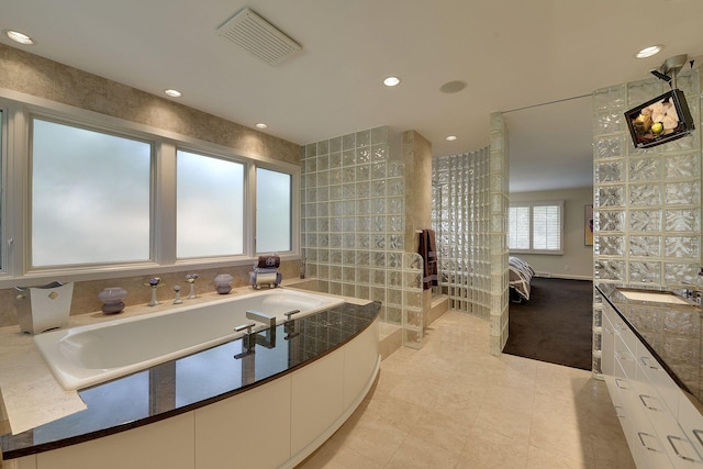 bathroom featuring tile walls, tile patterned flooring, and vanity