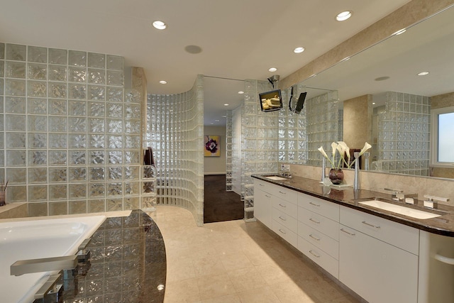 bathroom featuring vanity, tile patterned floors, and tile walls