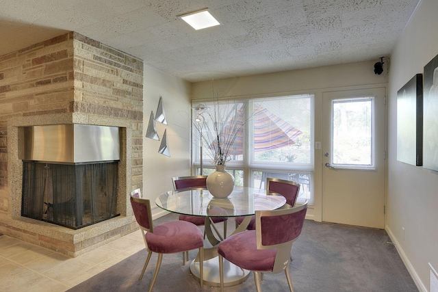 dining room featuring a multi sided fireplace and carpet floors