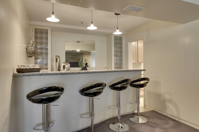 kitchen featuring decorative light fixtures and a kitchen breakfast bar