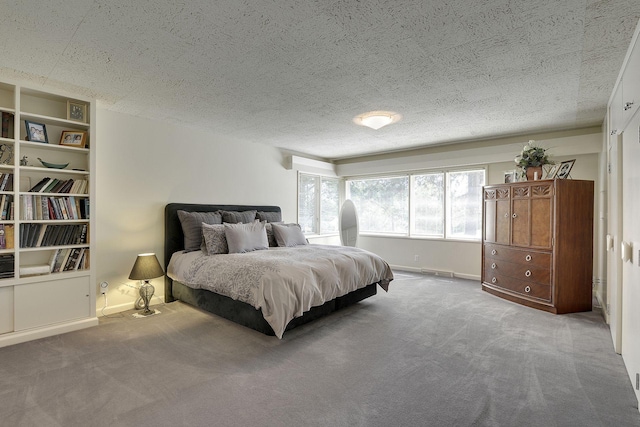 bedroom featuring a textured ceiling and carpet