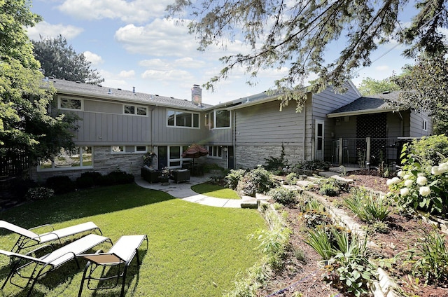 back of property featuring a patio area and a lawn