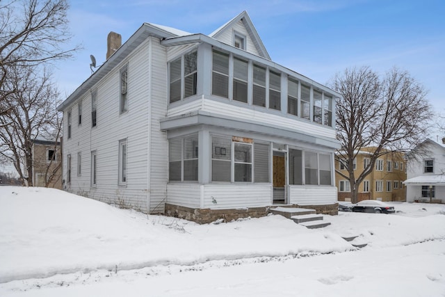 view of front facade with a sunroom