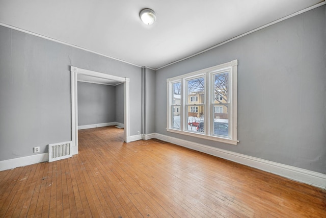 empty room with hardwood / wood-style flooring