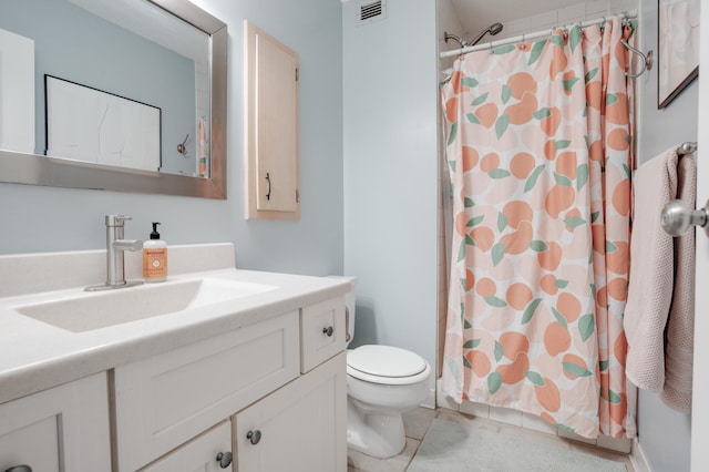 bathroom with tile patterned flooring, vanity, toilet, and curtained shower