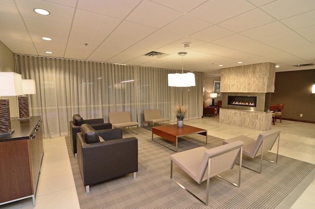 living room with a fireplace and light tile patterned floors