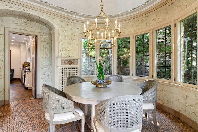 interior space featuring an inviting chandelier and crown molding