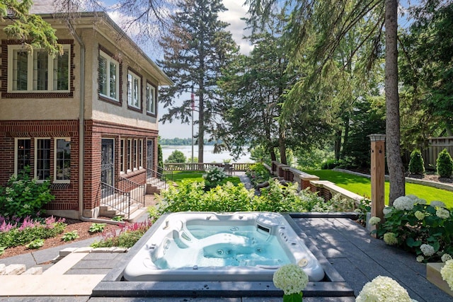 entry to storm shelter with fence and a jacuzzi