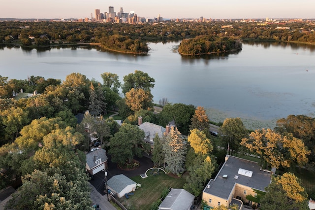 aerial view at dusk featuring a water view