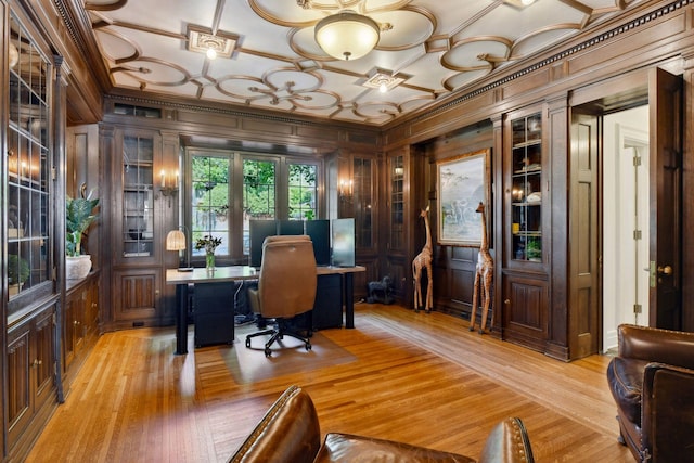 office featuring crown molding, wooden walls, and light wood finished floors