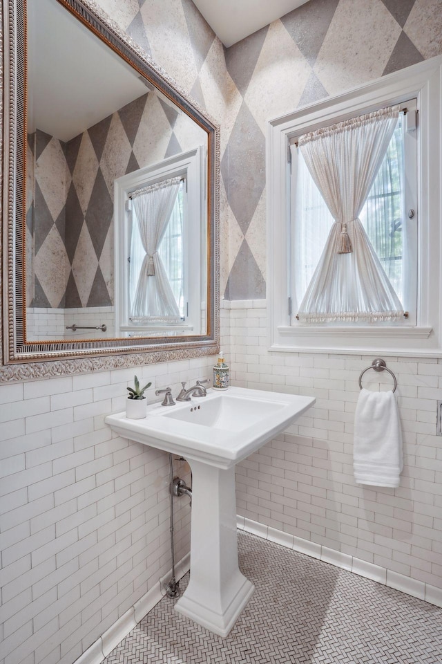 bathroom with tile walls and tile patterned flooring