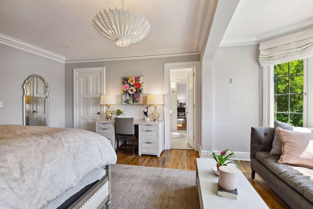 bedroom with baseboards, ornamental molding, a chandelier, and wood finished floors