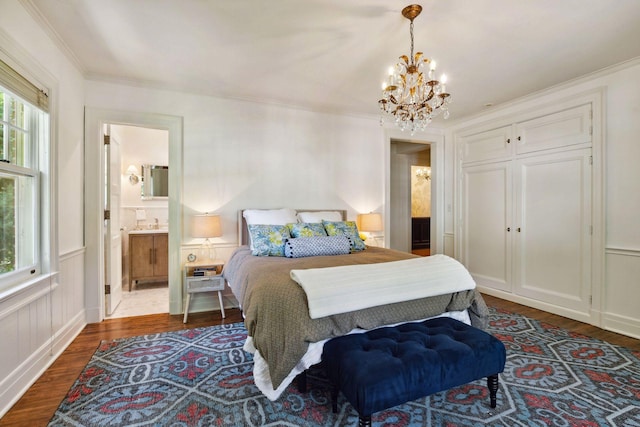 bedroom featuring ornamental molding, an inviting chandelier, and dark wood-type flooring