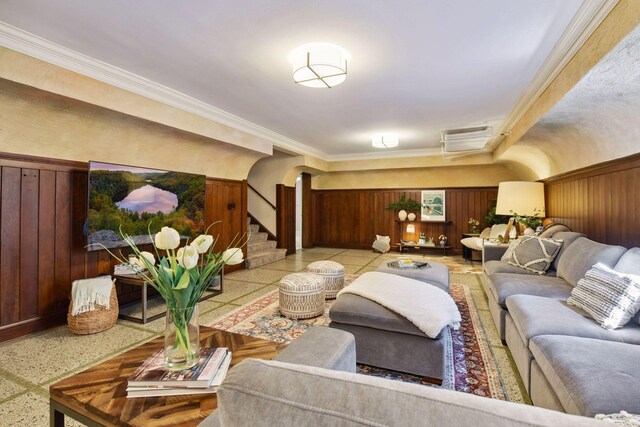 interior space featuring ornamental molding and wooden walls